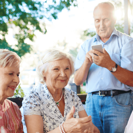 What does downsizing mean for Seniors? a group of seniors are smiling and having a nice time together.