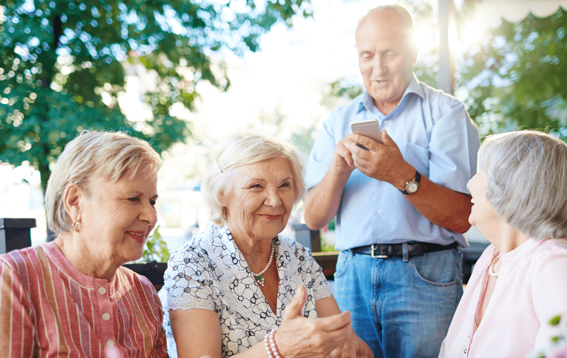 What does downsizing mean for Seniors? a group of seniors are smiling and having a nice time together.