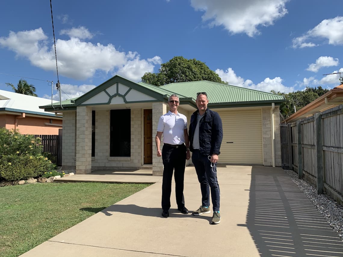 Buyer's Agent Sam Price standing with a client out the front of a property he assisted in the purchase of