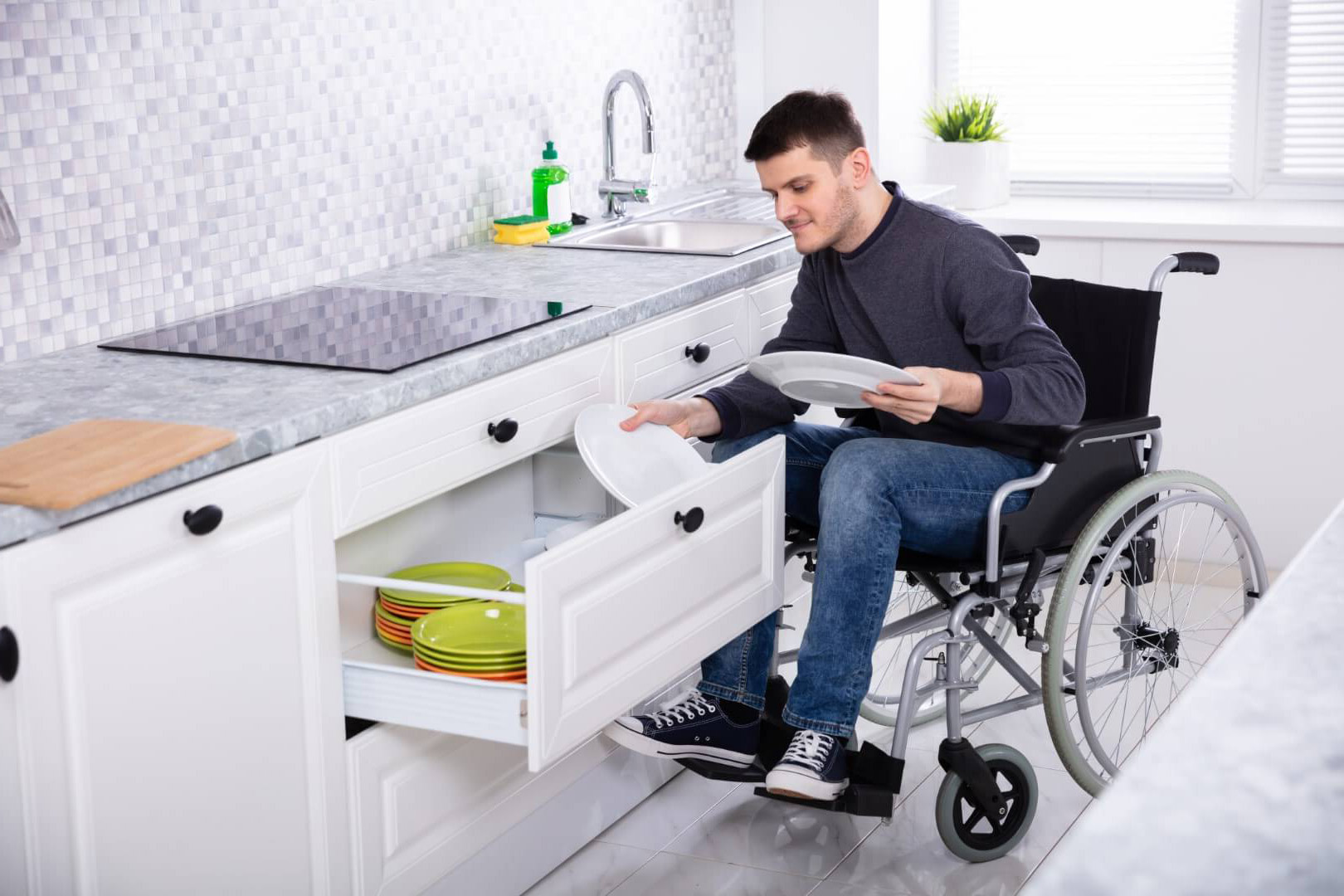 A man in a wheelchair in a home that meets his specific requirements
