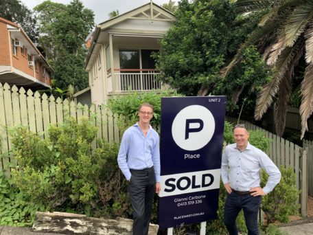 Picture of Brisbane Buyer's Agent Sam Price and selling agent outside of a house he purchased for a client. 