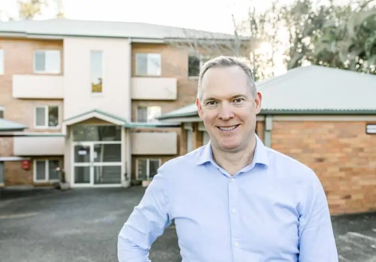 Sam Price of Templeton Property in front of an apartment building