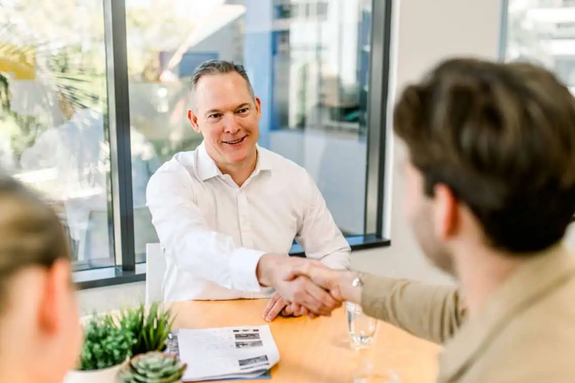 Sam Price of Templeton Property shaking hands with a client