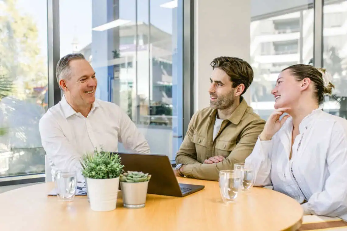 Sam Price from Templeton Property talking with clients about our auction bidding service in Brisbane