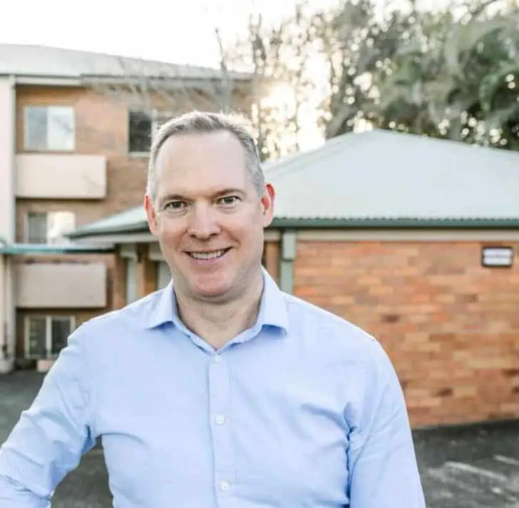 Sam Price, Brisbane Buyer's Agent, outside a low-maintenance brick unit block