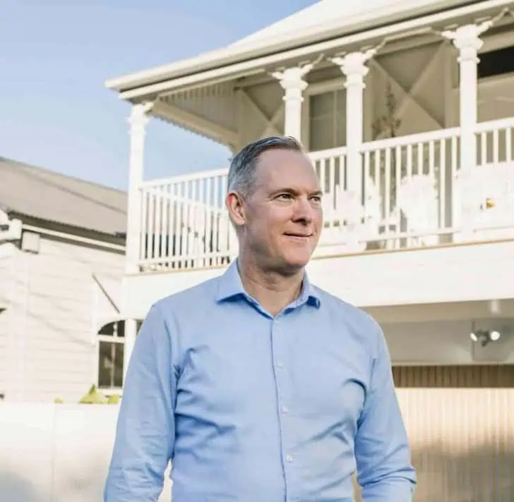 Sam Price, Brisbane Buyer's Agent, outside a Queenslander family home